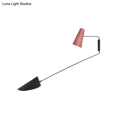Modern gray cone duckbill wall sconce with black rod featuring matte black and rose gold shades for light living room use