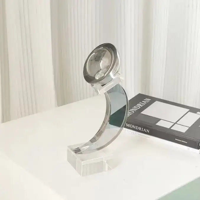 A sleek modern desk lamp with polished chrome finish and curved acrylic base for decorbites geometric crystal glass decor