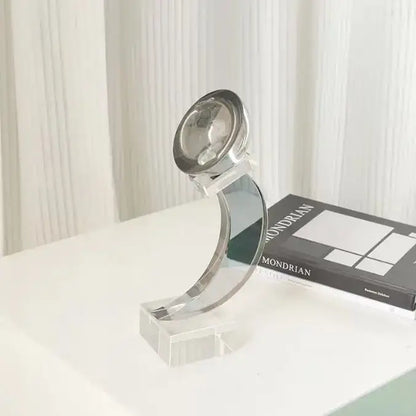 A sleek modern desk lamp with polished chrome finish and curved acrylic base for decorbites geometric crystal glass decor