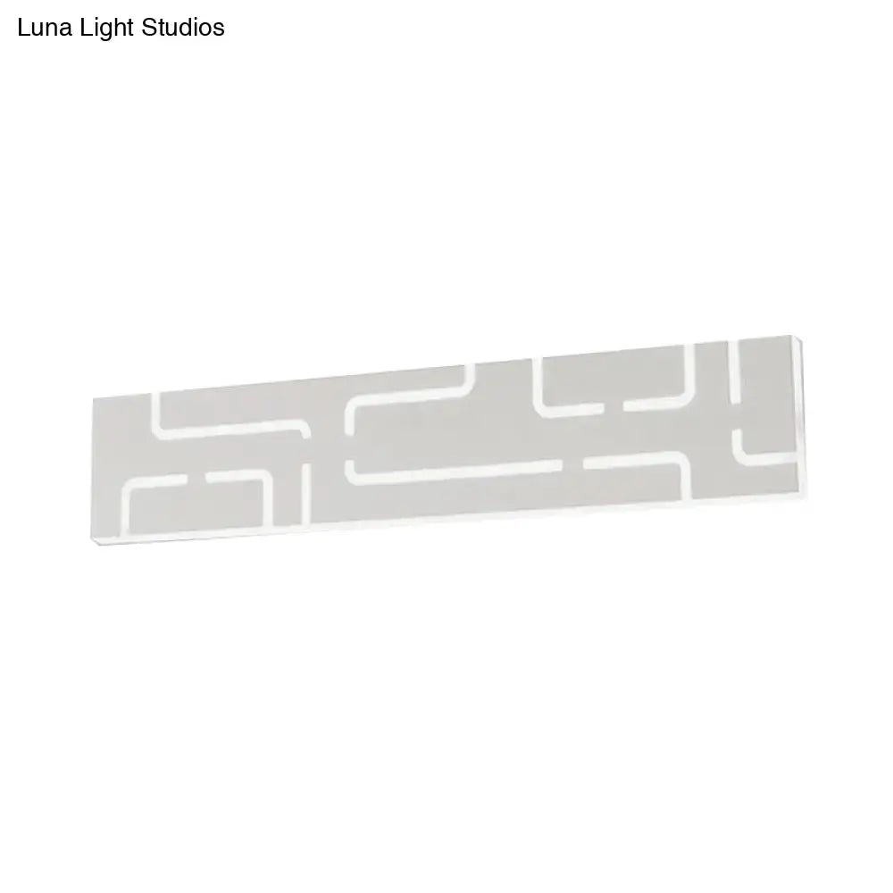 A sleek modern gray geometric led wall sconce with matte finish and warm white light for direct wired electric use