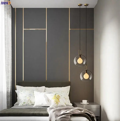 Modern gray decorbites glass ball led pendant light with clear glass globes and gold fixtures above the bed in dining room