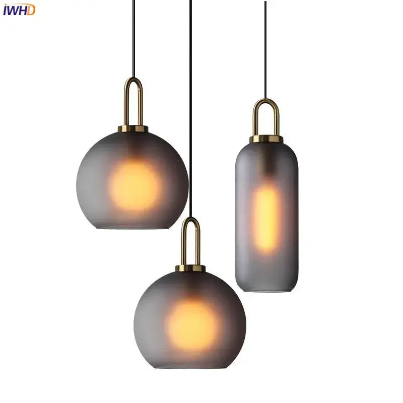 Set of three modern gray glass ball led pendant lights with frosted shades and brass accents for dining room decorbites