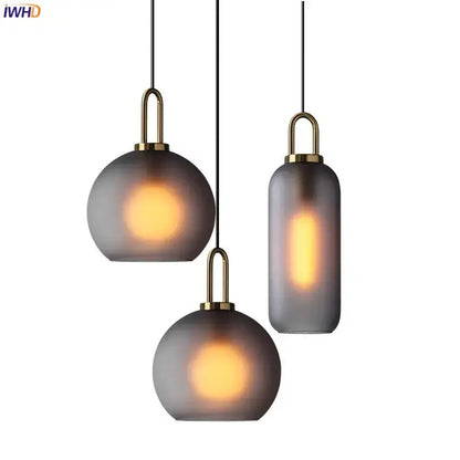 Set of three modern gray glass ball led pendant lights with frosted shades and brass accents for dining room decorbites