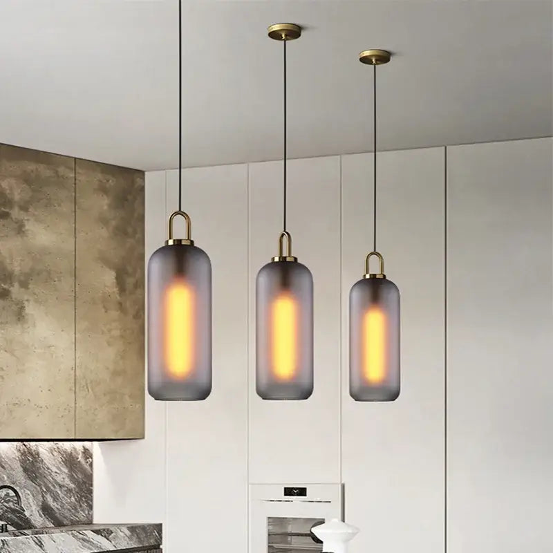 Three modern gray glass ball led pendant lights with frosted shades and brass accents for dining room decorbites glass ball decor