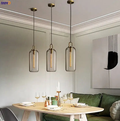 Three modern pendant lights with clear glass cylindrical shades and brass finish for dining room decorbites glass ball led