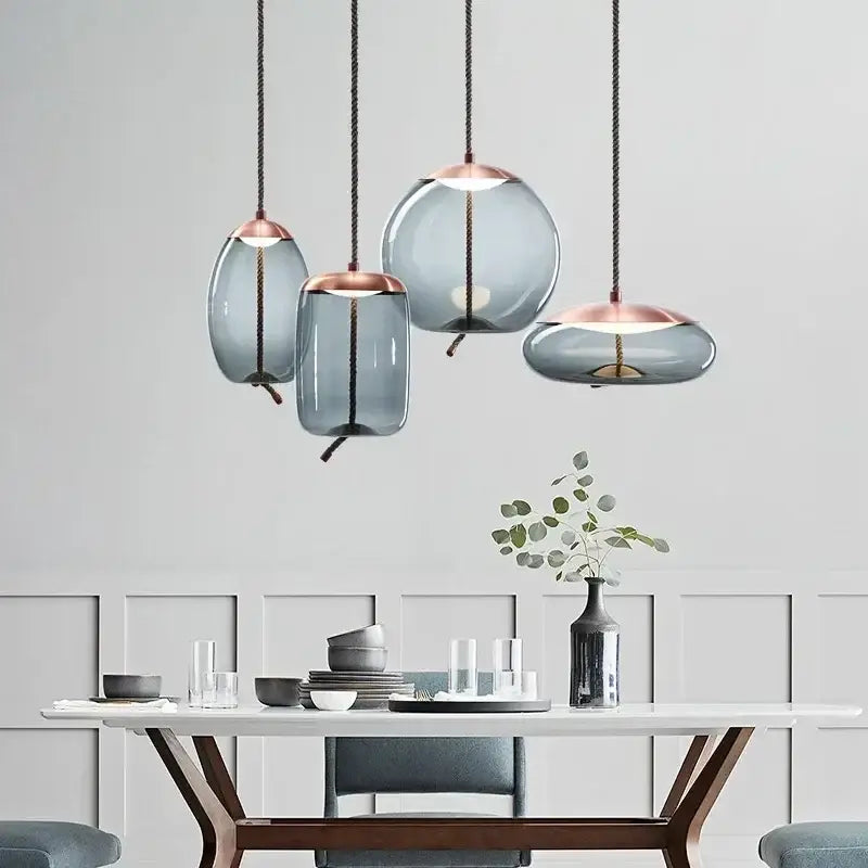 Modern gray glass knot pendant chandelier light with frosted gray glass shades and rose gold accents for dining room