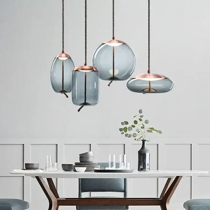Modern gray glass knot pendant chandelier light with frosted gray glass shades and rose gold accents for dining room