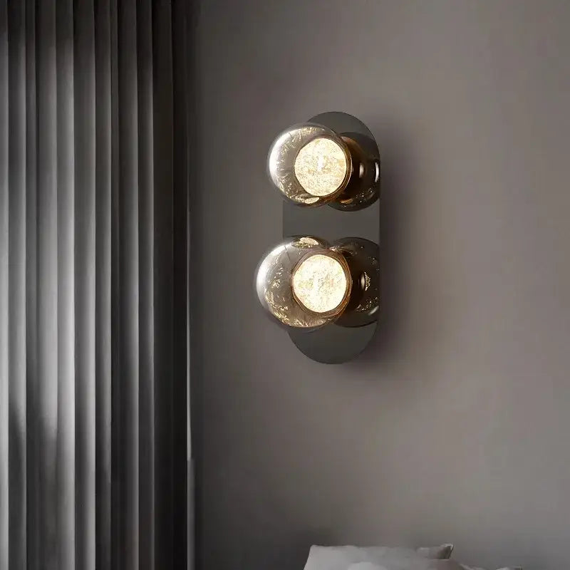 Modern double-bulb wall lights with frosted gray glass globes and brushed brass accents for living room wall lighting
