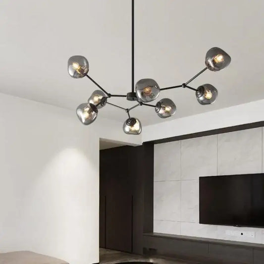 Modern black metal chandelier with frosted glass globe shades featuring gray lava glass for dining room lighting