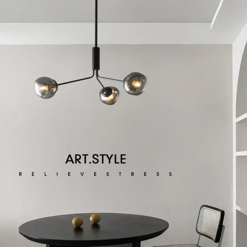 Modern black metal chandelier with three spherical smoked gray lava glass shades for dining room lighting