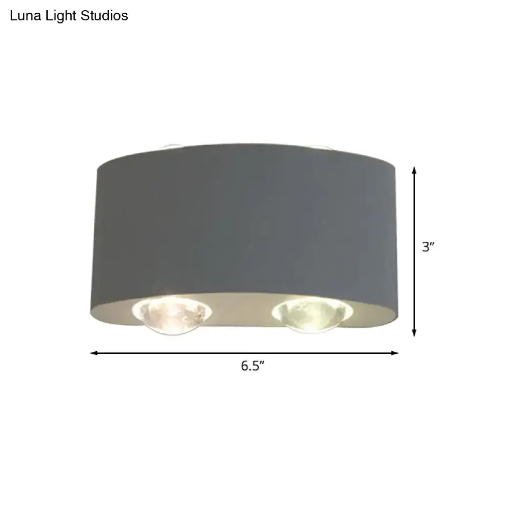 Modern gray metal piece cylindrical sconce lighting with two illuminated bulbs for living room ceiling use