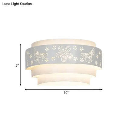 Modern gray metal wall sconce with flower-patterned etched frosted glass shades for warm living room lighting