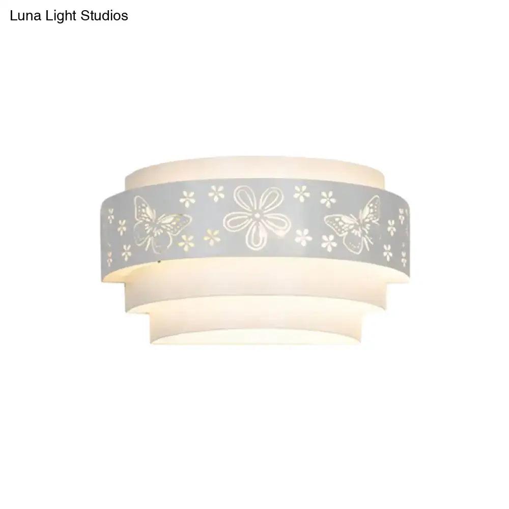 Modern gray metal wall sconce with delicate butterfly and flower etched pattern for warm living room light