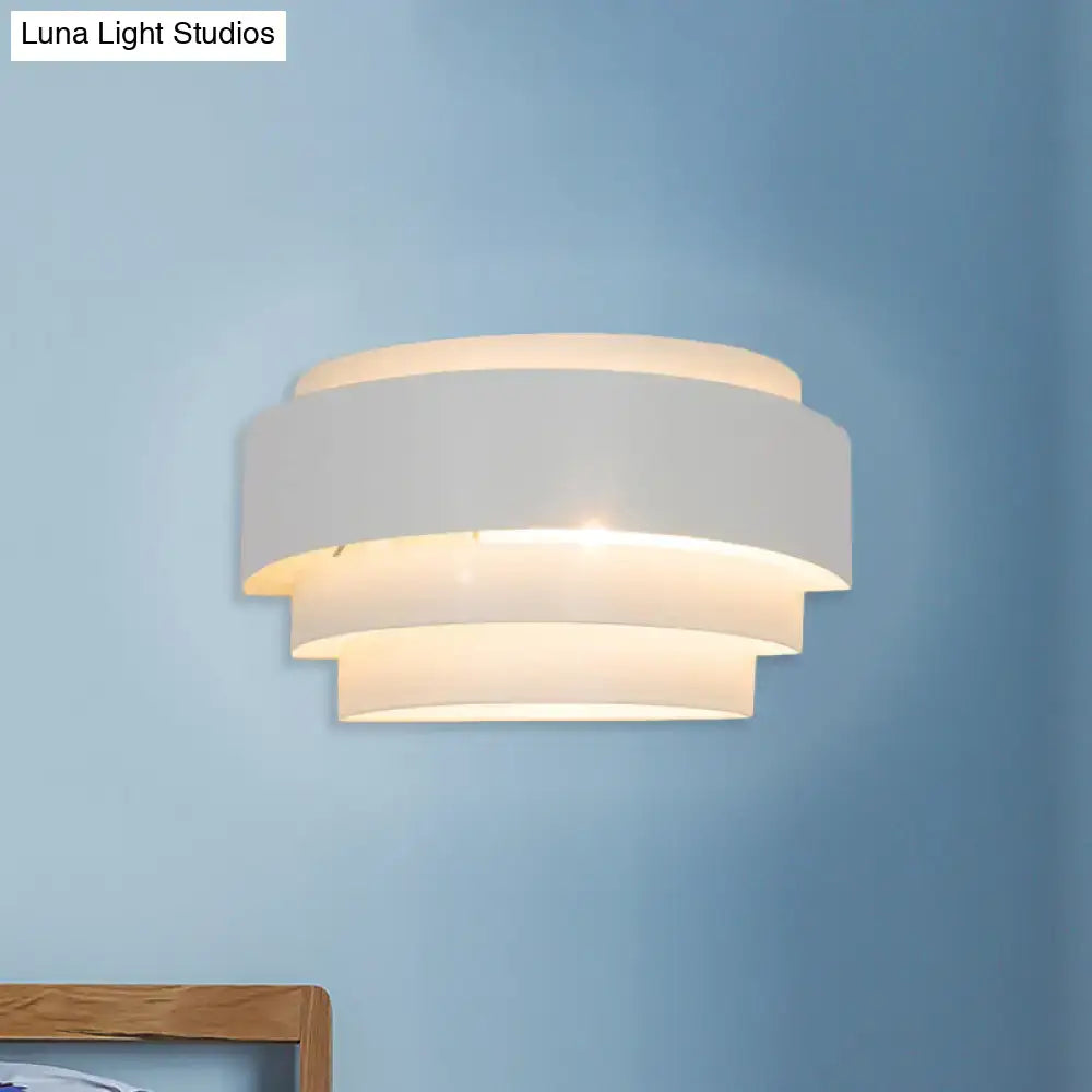 Modern gray metal wall sconce with etched pattern and warm glow ideal for living room lighting