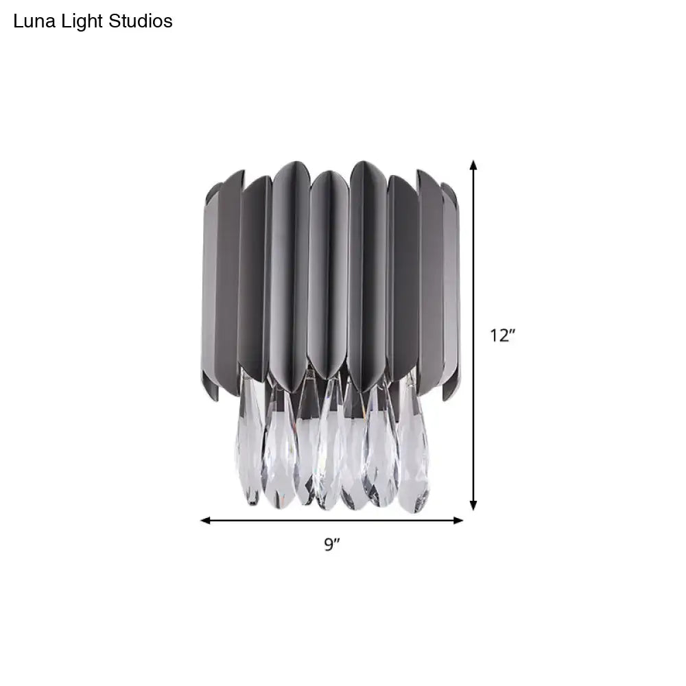 Modern gray metallic wall sconce with crystal teardrop pendants and vertical fluted panels for bedroom lighting