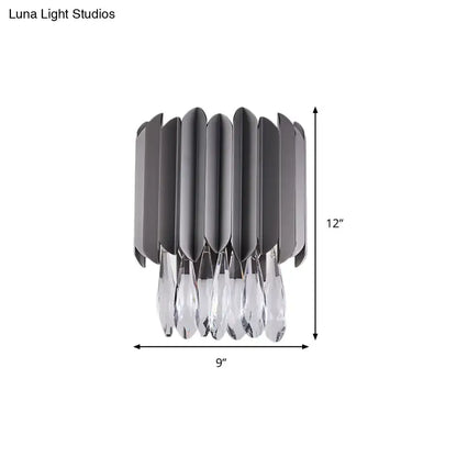 Modern gray metallic wall sconce with crystal teardrop pendants and vertical fluted panels for bedroom lighting