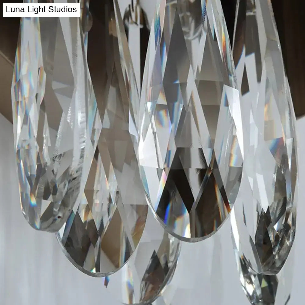 Clear faceted crystal teardrop pendants hanging from a modern gray metallic crystal teardrop wall sconce bedroom light