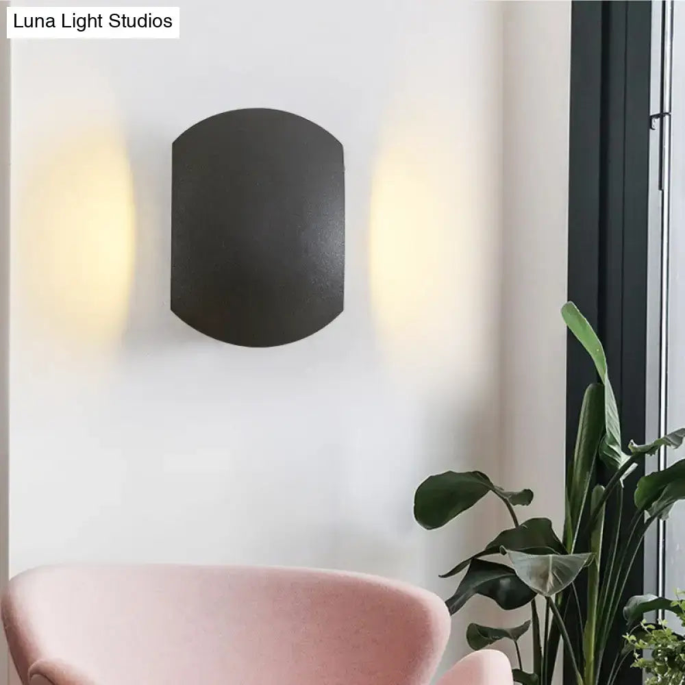 Black arched wall light with matte finish and bulb included providing warm white outdoor illumination