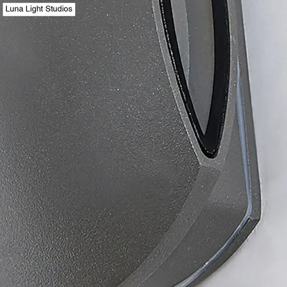 Modern gray oval wall light with warm white bulb included and sleek gray textured mousepad with black trim edge