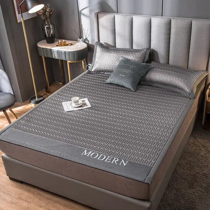 Modern gray quilted cooling latex bed mat with white embroidered edge for enhanced comfort and temperature control