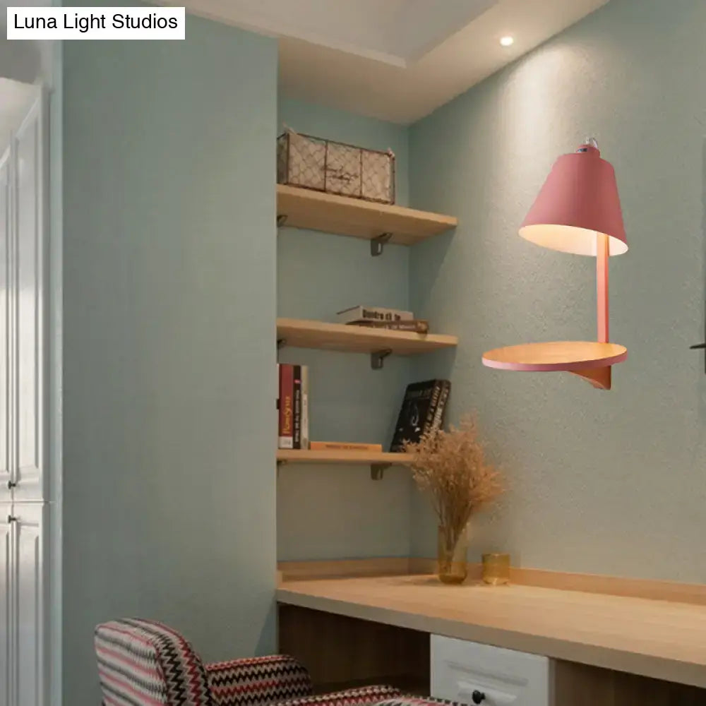 Pink conical lamp with wooden base and slender stem above desk in modern gray tapered shade wall sconce with wooden shelf