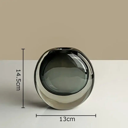 A sleek round glass vase in gradient gray with a glossy finish for artificial flowers home decor