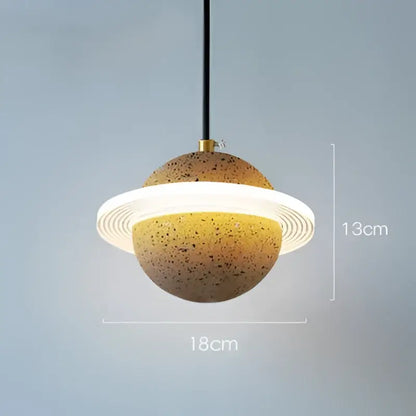 Modern gray and white cement planet pendant light with speckled earthy body and glowing ring for bedroom decorbites pendant light