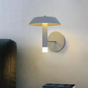Modern gray and white wall sconce with a bulb base emitting warm yellow light for bedroom LED light type use