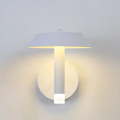 Modern gray and white wall sconce with a sleek bulb base and flat disc lampshade light type for bedroom use