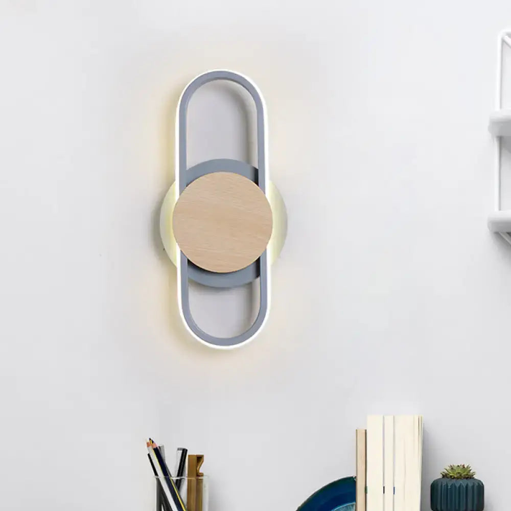 Modern gray and wood geometric led sconce with white light featuring a minimalist circular design for bedroom lighting