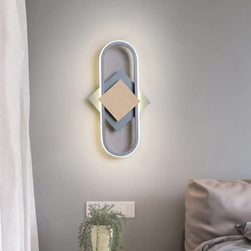 Modern gray and wood geometric led sconce with oval frame and white light for bedroom illumination