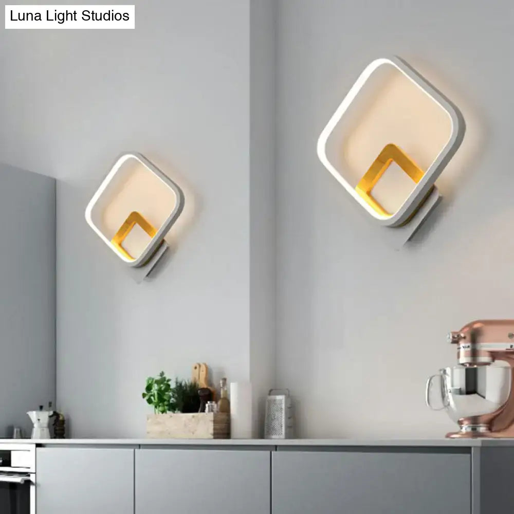 Modern gray and yellow square wall sconce with white frame and gold interior accent emitting warm light 110v-120v wall sconce