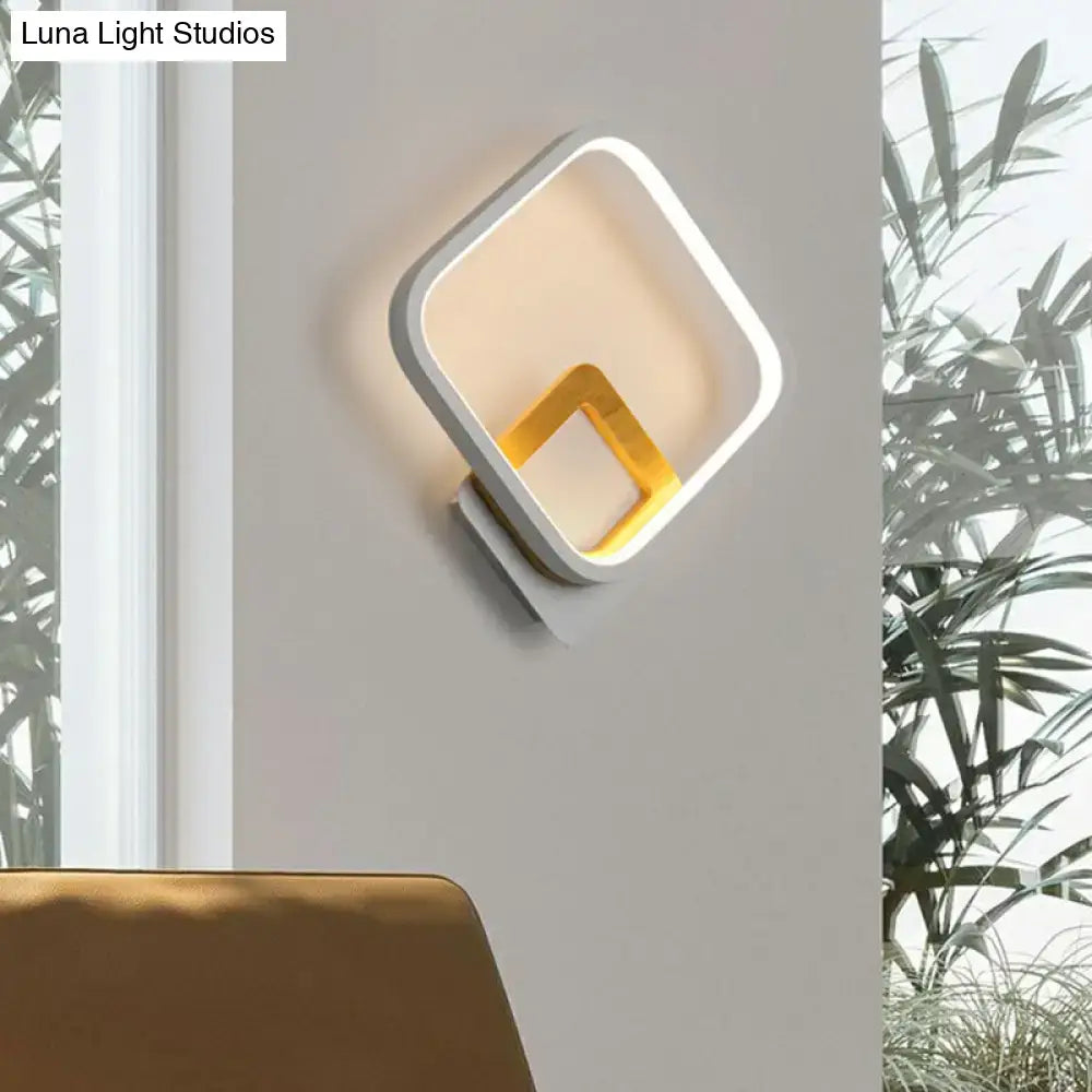 Modern gray and yellow wall sconce with white square frame and gold inner detail emitting warm light 110v-120v use