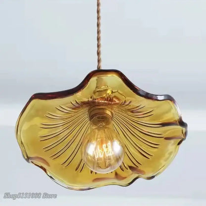 Modern green and amber colorful glass pendant light with scalloped leaf design and etched radial patterns for dining room