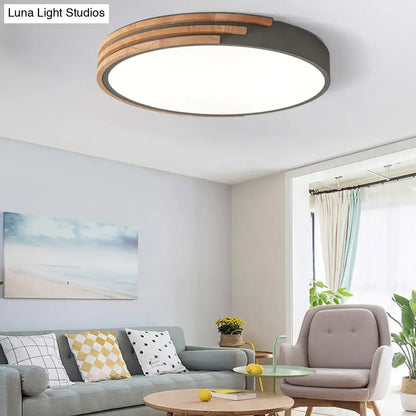 Modern round flush mount ceiling light by DecorBites with dark metal frame and concentric wooden slats in grey white green