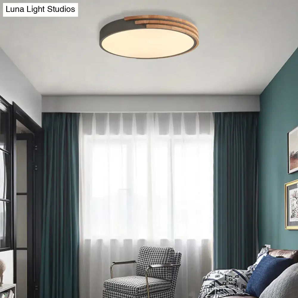 Modern round flush mount ceiling light by DecorBites with dark metal frame and three concentric wooden rings in grey white green
