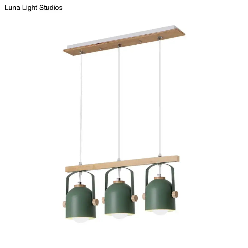 Modern green metal dome island light with wooden accents featuring three hanging lampshades by decorbites