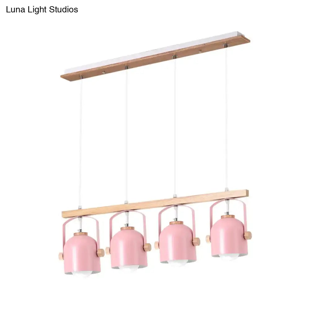 Pink metal pendant dome island light with wooden accents hanging from matching wood bar for kitchen island lighting