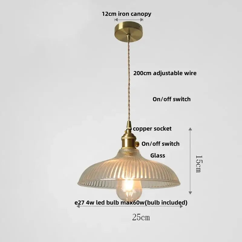 Antique brass-finished pendant light with ribbed translucent glass shade and adjustable copper wire for dining room use