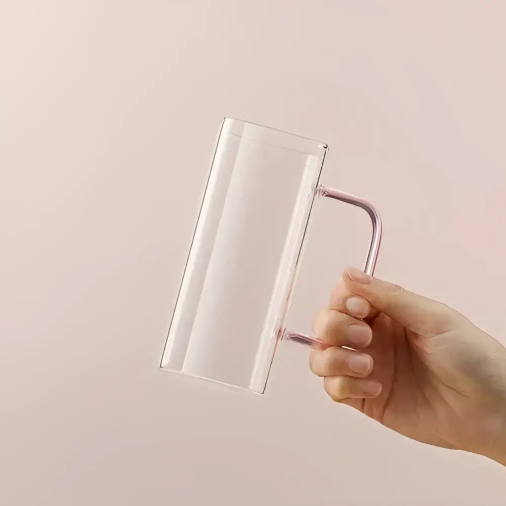 Clear glass square glass mug with a sleek rose gold metal handle for modern kitchen drinking use
