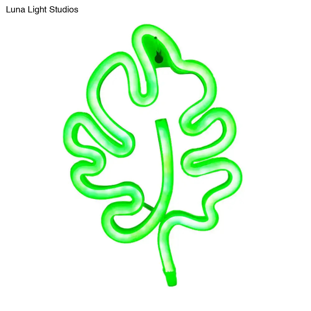 A modern green leaf neon sign itty bitty wall light with a glowing outline and remote control for bedroom use