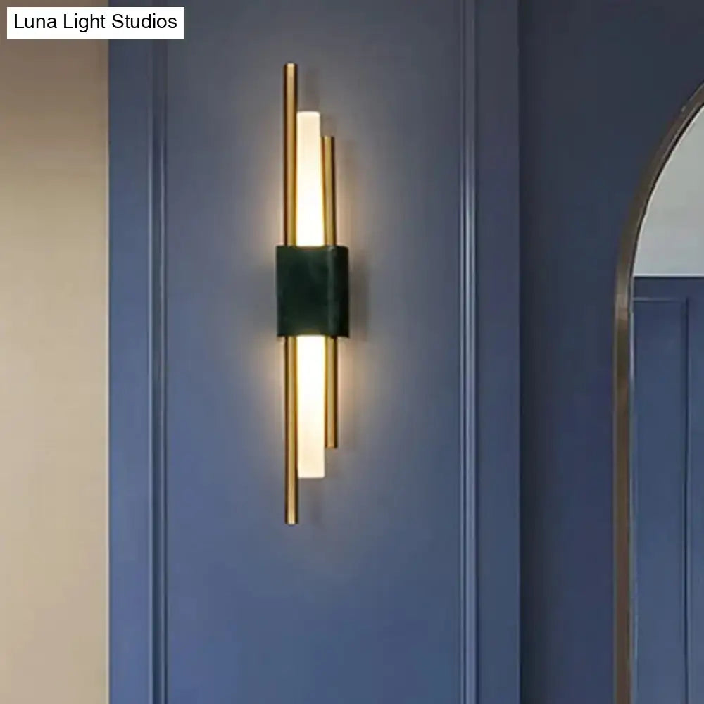 Modern green marble and gold wall sconce light with sleek gold metal frame and dark green fabric wrap for bedroom decor