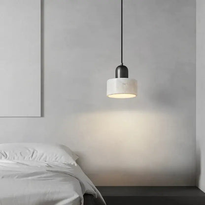 Modern green marble led pendant light with a black metal fixture and white cylindrical marble shade for kitchen lighting