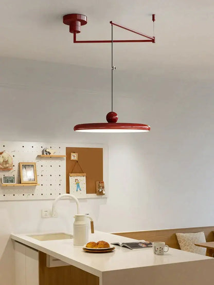 A modern red colorful metal led pendant light with a sleek circular lampshade for kitchen decorbites pendant lights