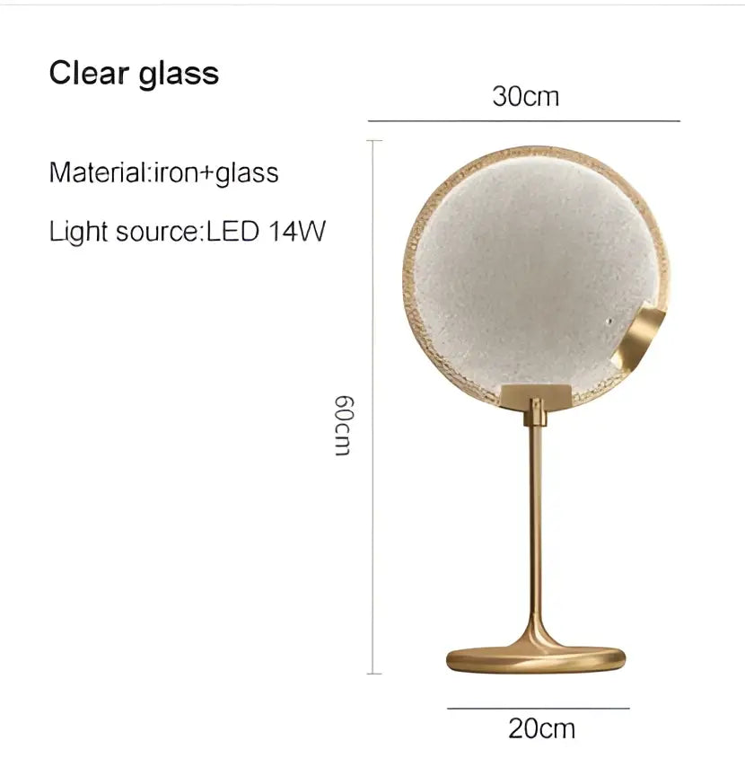 A round vanity mirror with textured clear glass and gold-toned iron stand complementing brass pendant light decorbites
