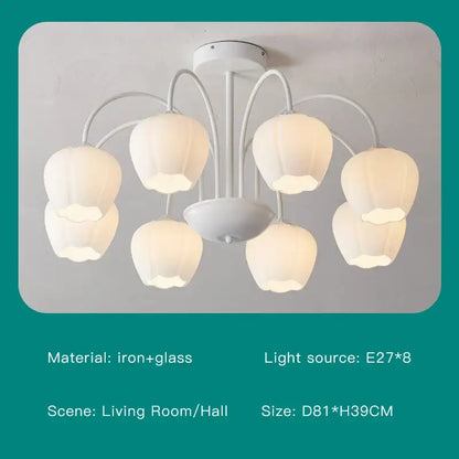 White chandelier ceiling light with six pear-shaped glass shades and iron arms for modern green white living rooms