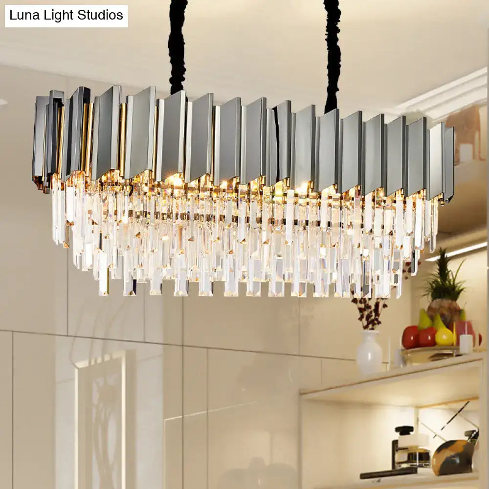 Modern grey crystal pendant chandelier with sleek silver and gold metallic bars and cascading clear crystal prisms for kitchen island