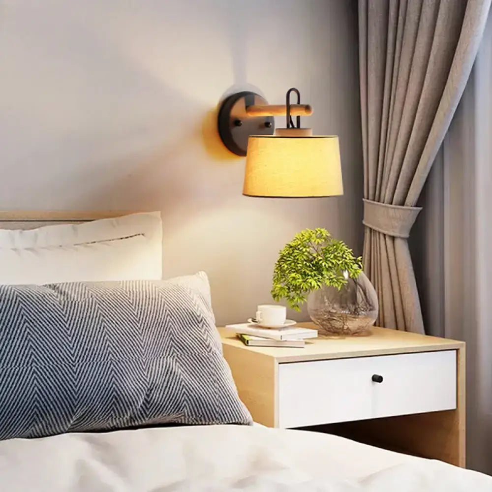 Modern grey drum shade wall lamp with wooden arm lighting fixture ideal for bedroom lighting with warm tones