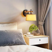 Modern grey drum shade wall lamp with wooden arm lighting fixture ideal for bedroom lighting with warm tones