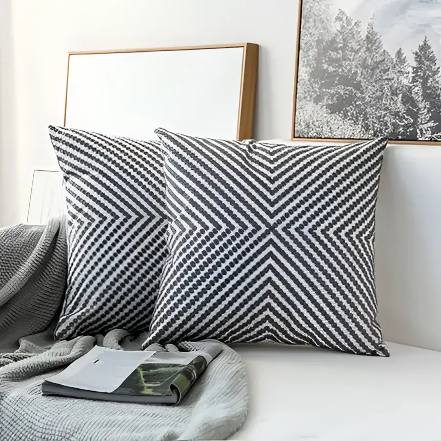 Two gray and white chevron-patterned modern geometric embroidered cushion covers with textured woven fabric for living room decorbites